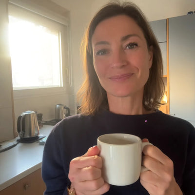 Woman drinking coffee in kitchen